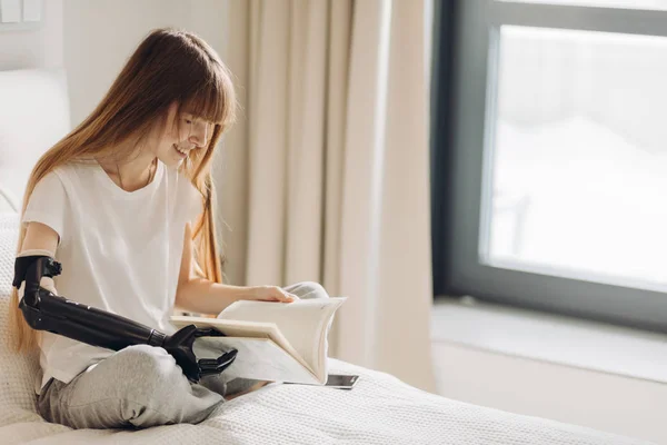 Disabled girl enjoys reading a book — Stock Photo, Image