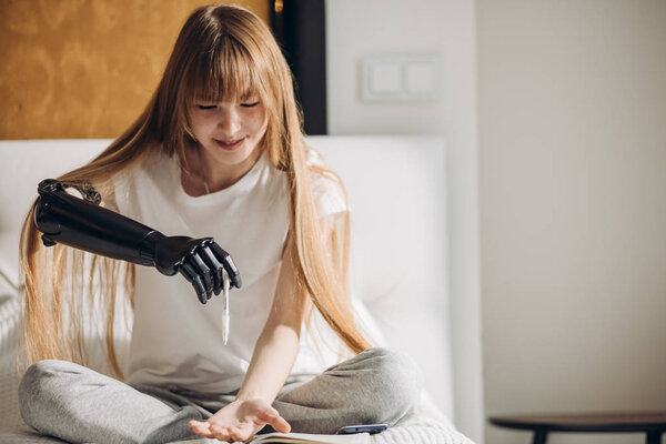 веселая девушка перекладывает ручку из одной руки в другую
