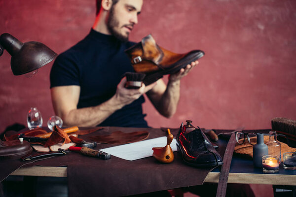 focus on polished leather shoe lying on the desk