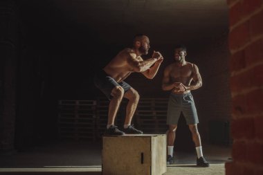 Kas çok ırklı atletik gör spor salonunda dışarı çalışırken kutusunu atlar yaparak