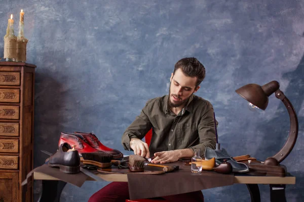 good looking guy making a draft of insoles in the modern room.