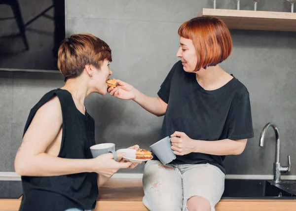 beautiful friends enjoying breakfast together in the kitchen