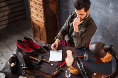 talented shoemaker making up an orthopedic insoles clipart