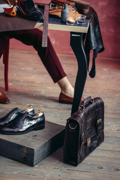 Hombre joven preparando zapatos limpios reparados para los clientes — Foto de Stock