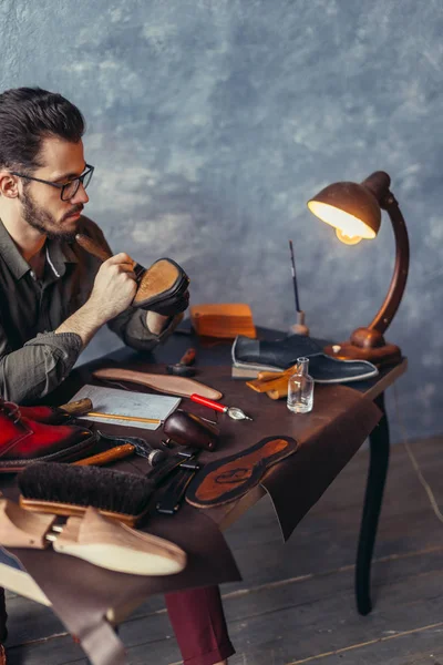 bearded male cleaning the heel of the shoes