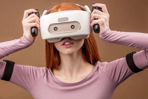 Happy young red-haired woman using a virtual reality headset — Stock Photo, Image