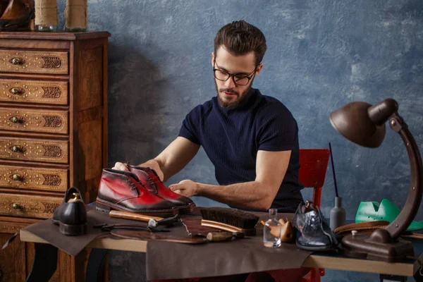 Stående ofpleasant shoemakerlooking för några repor på skor — Stockfoto