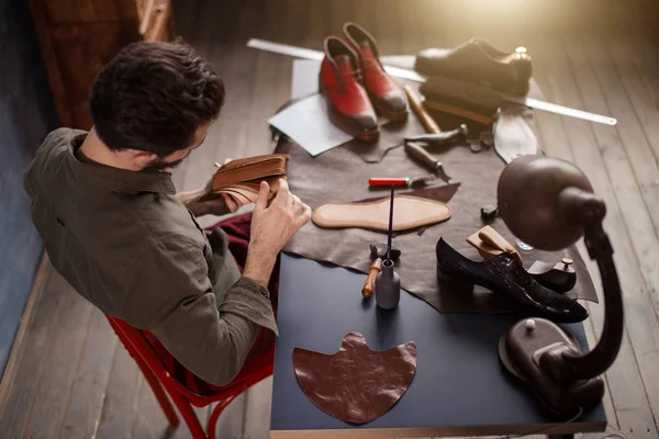 Hombre seleccionando cuero para coser zapatos — Foto de Stock