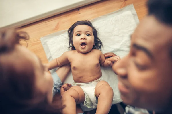 Happy little girl lying in napping and looking at the camera — Stock Photo, Image