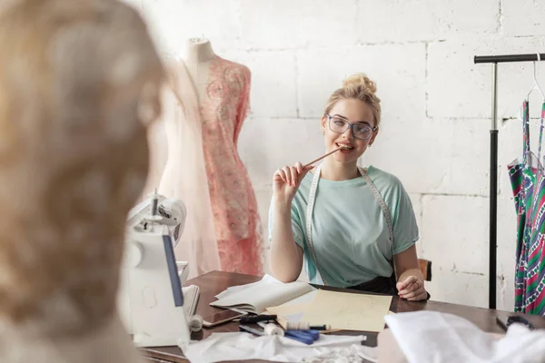 Mode-ontwerper op het werk. Talanted naaister het tekenen van de schets op haar werkruimte — Stockfoto