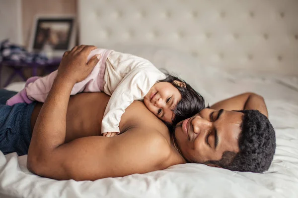 Мужчина получает удовольствие от того, что лежит с любимой дочерью — стоковое фото