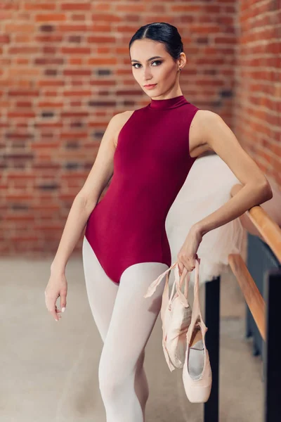 Елегантна витончена танцівниця в червоному купальнику дивиться на камеру — стокове фото