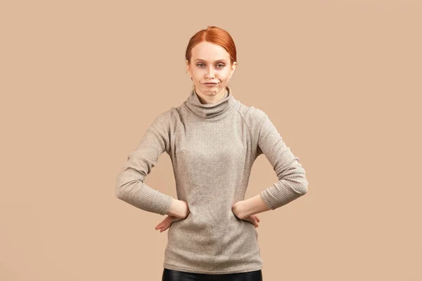 Skinny woman with sad and disappointed expression, keeping hands on both sides