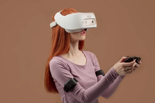 Happy young red-haired woman using a virtual reality headset — Stock Photo, Image