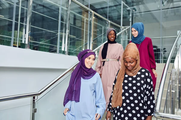 Grupo de cuatro chicas musulmanas caminando por las escaleras del centro comercial — Foto de Stock