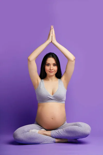 pregnant woman practicing prenatal yoga, preparing body to natural childbirth