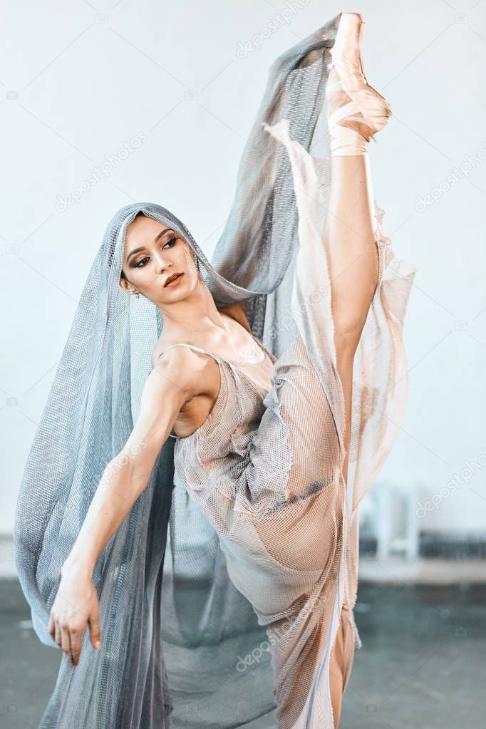 Beautiful young ballet woman dancer on stage with harmony, body shape movements