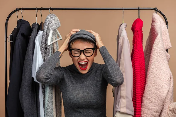 mad funny woman holding her head while shopping