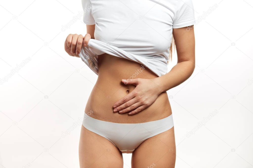 Healthy stomach health concept, early pregnancy concept. Caucasian woman model.