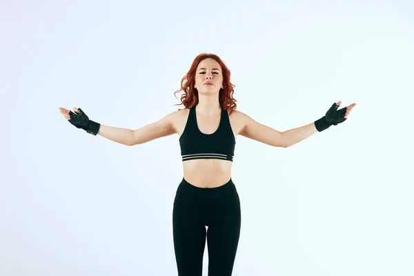 Female red-haired boxer in black sportswear posing on white background — Stock Photo, Image
