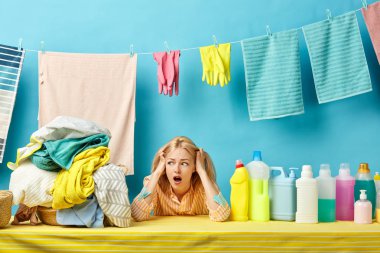 scred surprised housewife holding her head, girl is afraid of dirty clothes clipart
