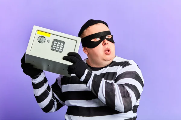 Maskeli suçlu hırsız veya hırsız adam açma kırmak için elinde bir kasa tutan — Stok fotoğraf