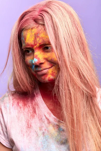 Happy smiling girl with colorful smeared face looking down — Stock Photo, Image