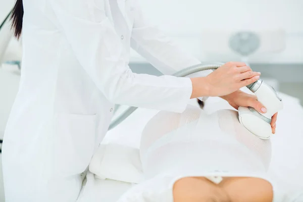 Beautiful brunette woman getting LPG massage for lifting body in LPG suit — Stock Photo, Image