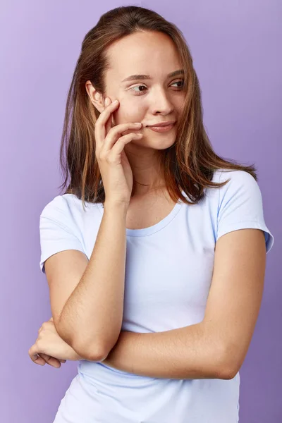 Smiling awesome woman in white T-shirt touching her face — Stock Photo, Image