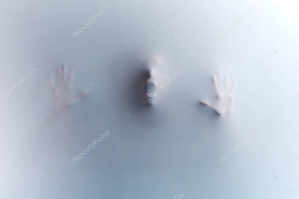 man touching the glass, leaning on it, expressing negative feeling, emotion