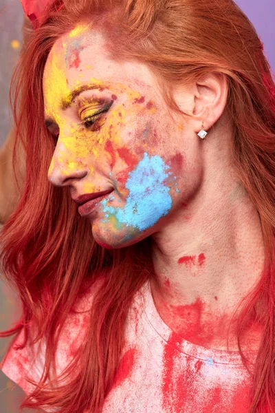 colorful female face. profile of beautiful woman with painting smears