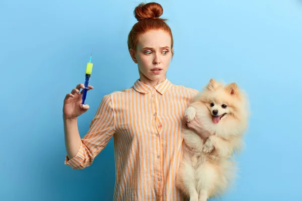 girl being shocked after bad reaction of dog on the injection