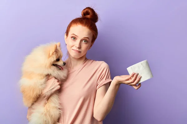 puzzled girl holding a dog and napkins