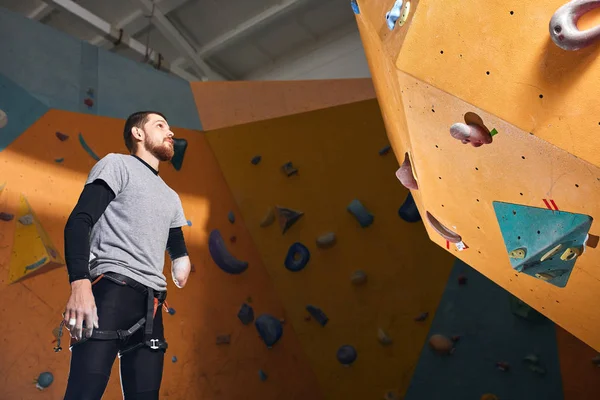 Sporty man with physical disability came to climbing training classes