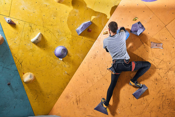 Strong rock climber preparing to the last mountain ascend in this season