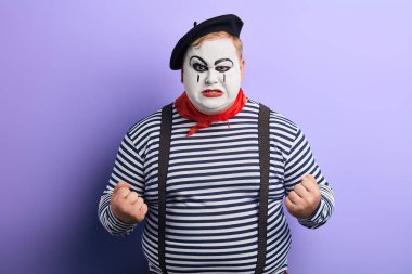Kameraya kızgın görünümlü sıkıştırılmış yumrukları ile Mime adam
