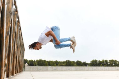 genç adam açık havada somersault yapmayı öğrenme