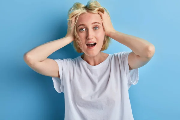 Fair-haired girl touching standing with palms on her head — Stock Photo, Image