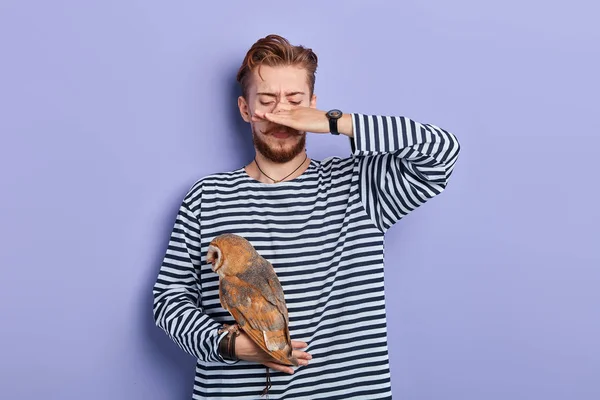 Man in striped jumper closing his nose with finger because his bird stinking — Stock Photo, Image