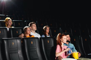 büyük ekranda yüksek kaliteli film izleyen bir grup insan