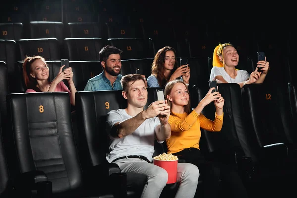 Joyful young people taking a photo while watching movie — Stock Photo, Image