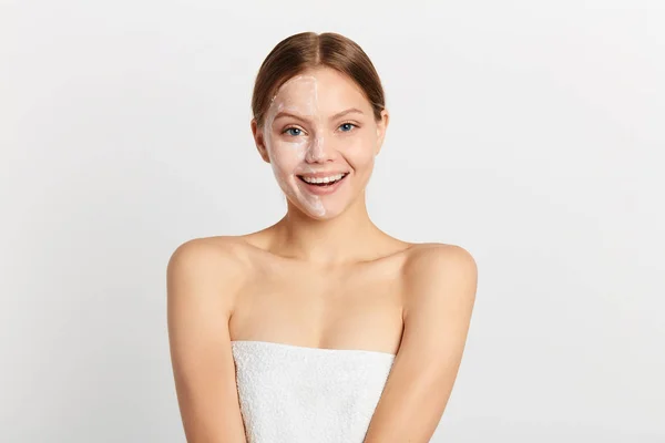 Gadis tersenyum dengan krim di wajahnya bersukacita prosedur efektif di spa salon — Stok Foto