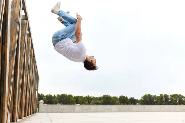young sportsman performing back flip