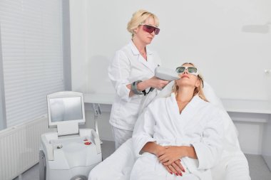 terapist kadın yüz soyma için tabanca kullanarak