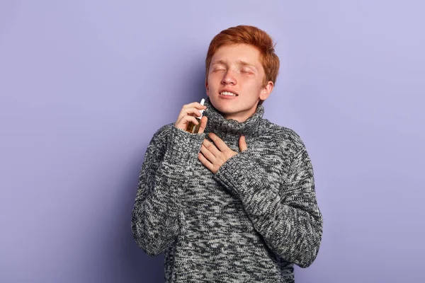 young smiling man feels better after using nasal drops