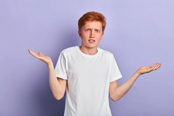 Young man cannot believe in news, guy showing ignorance on a blue background — Stock Photo, Image