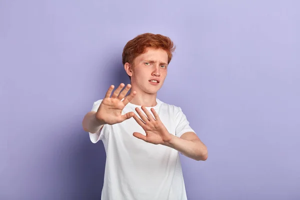 Young scared man shows refusal gesture — Stock Photo, Image