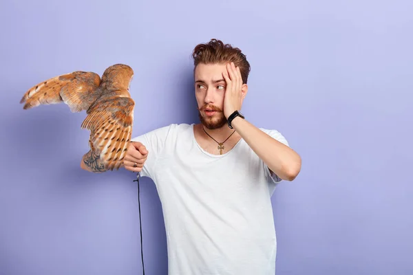 Sad unhappy young man touching his forehead with a palm — Stock Photo, Image