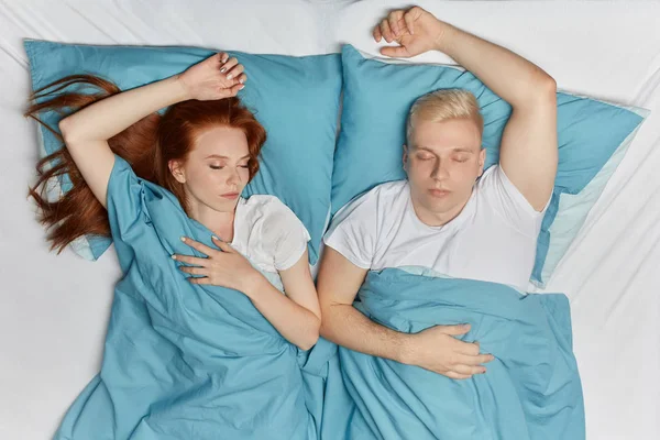 Attractive relaxed couple sleeping in their bed at home in bedroom — Stock Photo, Image