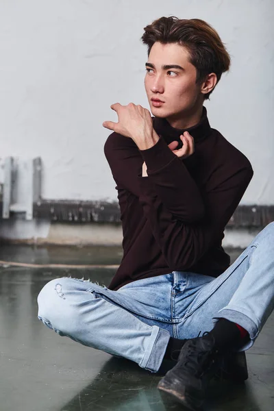 Handsome young asian man warming up his arms before dancing — Stock Photo, Image